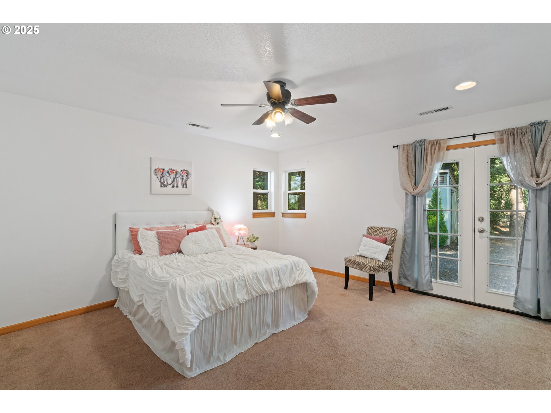 15014 Northeast Caples Road Brush Prairie, WA 98606 - Photo 22 of 39 a bedroom with a bed and a chandelier