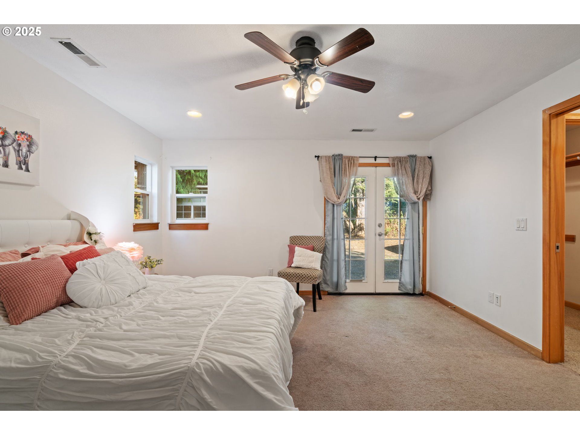 15014 Northeast Caples Road Brush Prairie, WA 98606 - Photo 23 of 39 a bedroom with a large bed and a chandelier