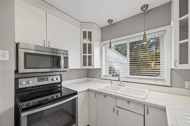 a kitchen with a sink and appliances