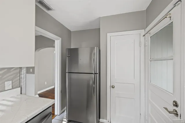 a white refrigerator freezer and a refrigerator in a kitchen