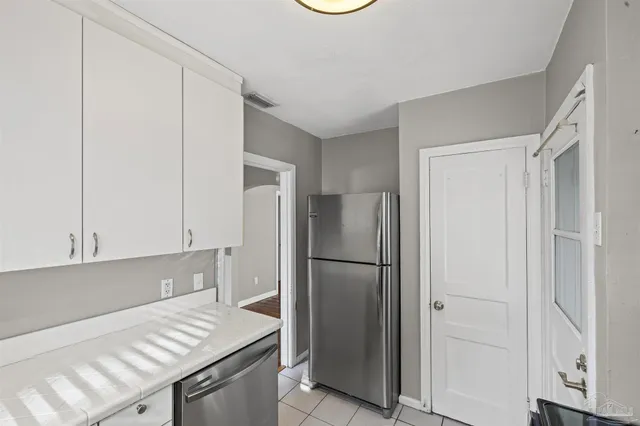 a kitchen with a refrigerator and a stove