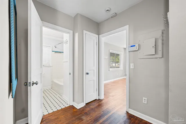 a view of a bedroom with wooden floor & bathroom