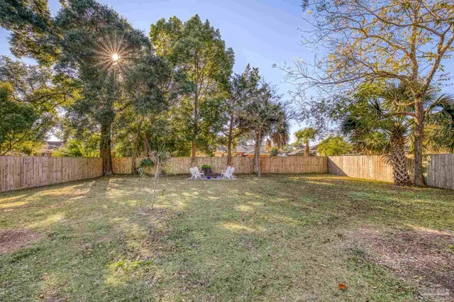 a view of yard with tree and trees