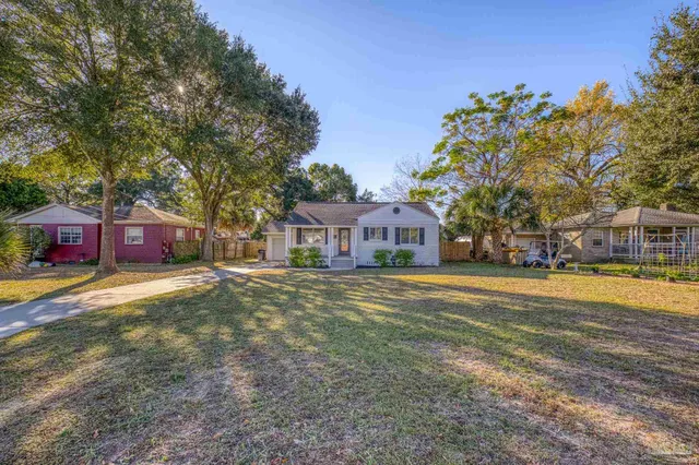 a front view of a house with a garden