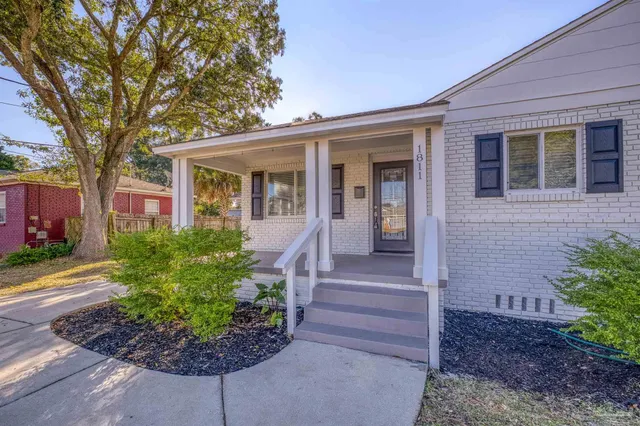 a front view of a house with a garden