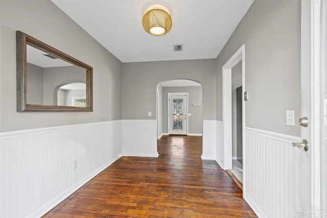 a view of a hallway with wooden floor