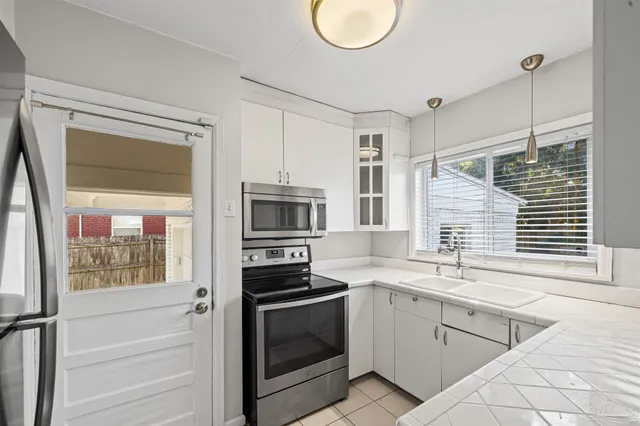 a kitchen with a sink stove and microwave