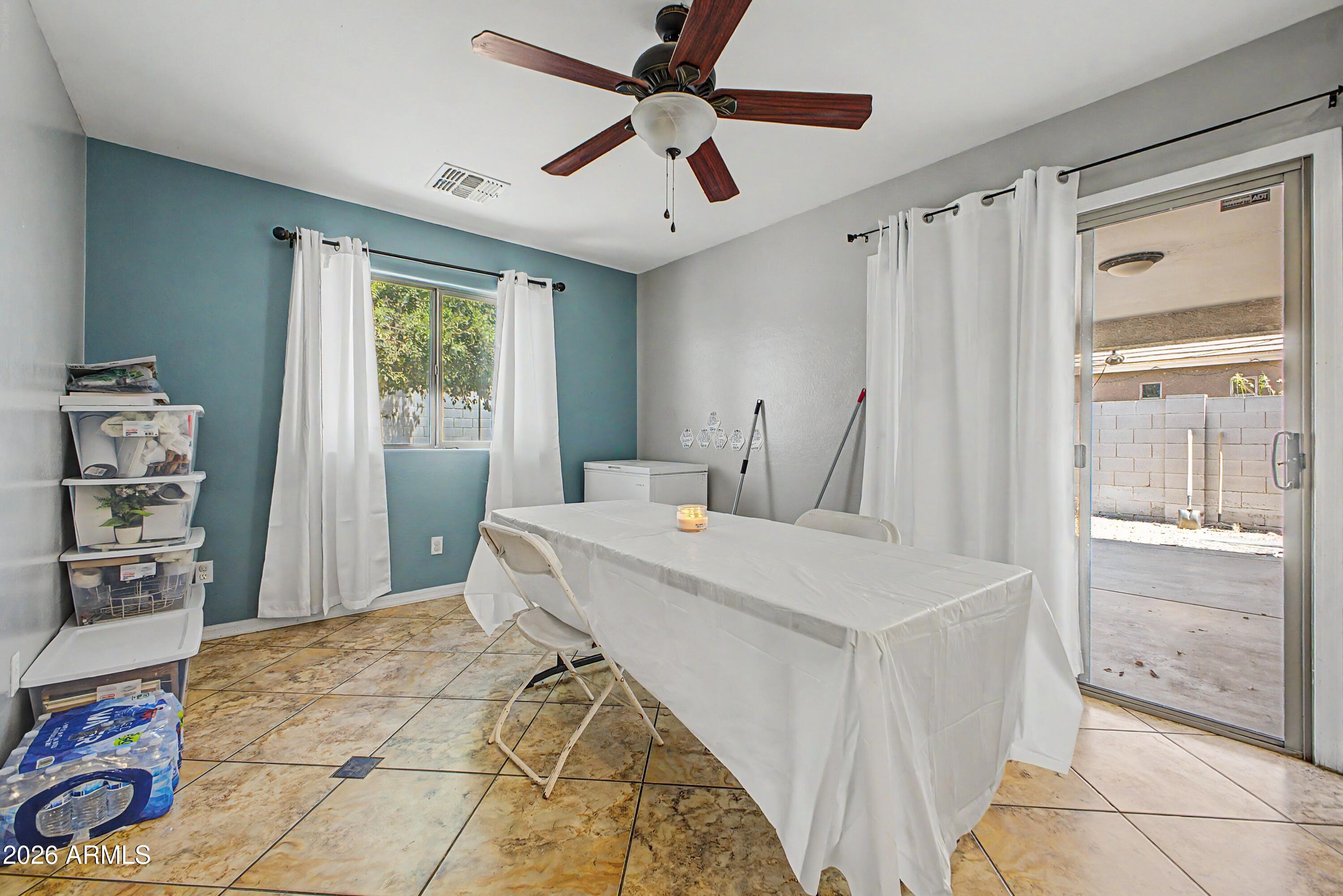 25652 West Rio Vista Lane Buckeye, AZ 85326 - Photo 12 of 32 a bedroom with a bed and a large window