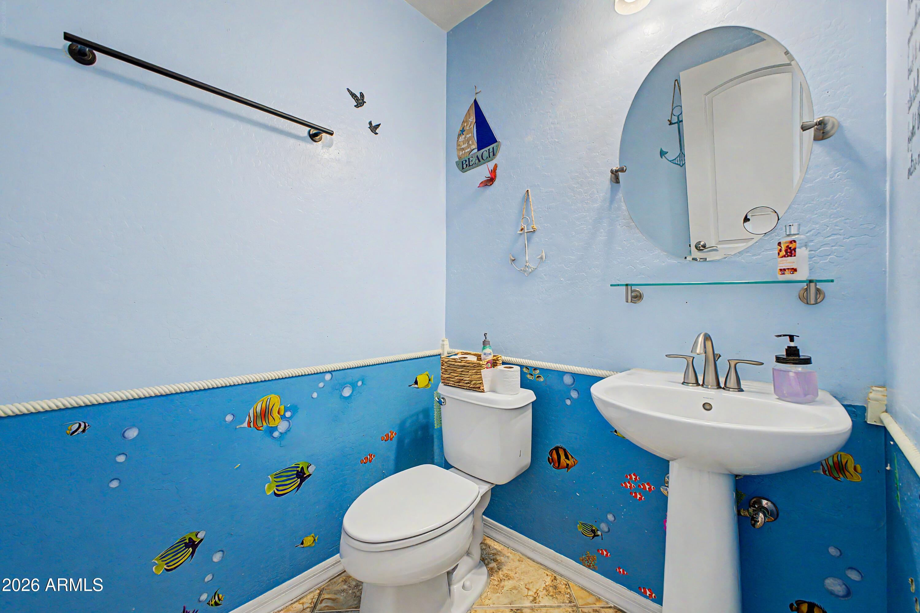 25652 West Rio Vista Lane Buckeye, AZ 85326 - Photo 16 of 32 a bathroom with a sink mirror and toilet