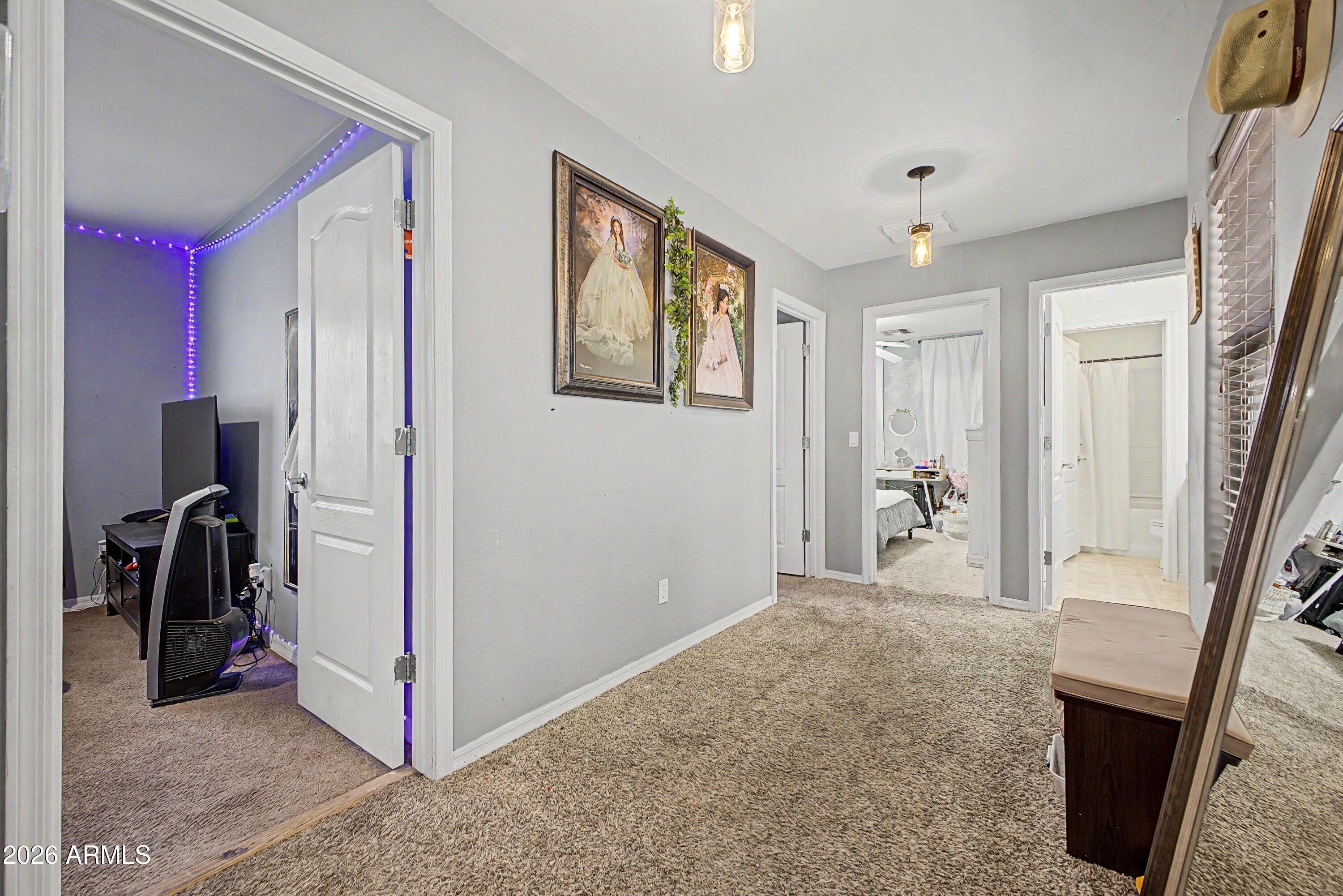 25652 West Rio Vista Lane Buckeye, AZ 85326 - Photo 21 of 32 a view of a hallway with closet and a livingroom
