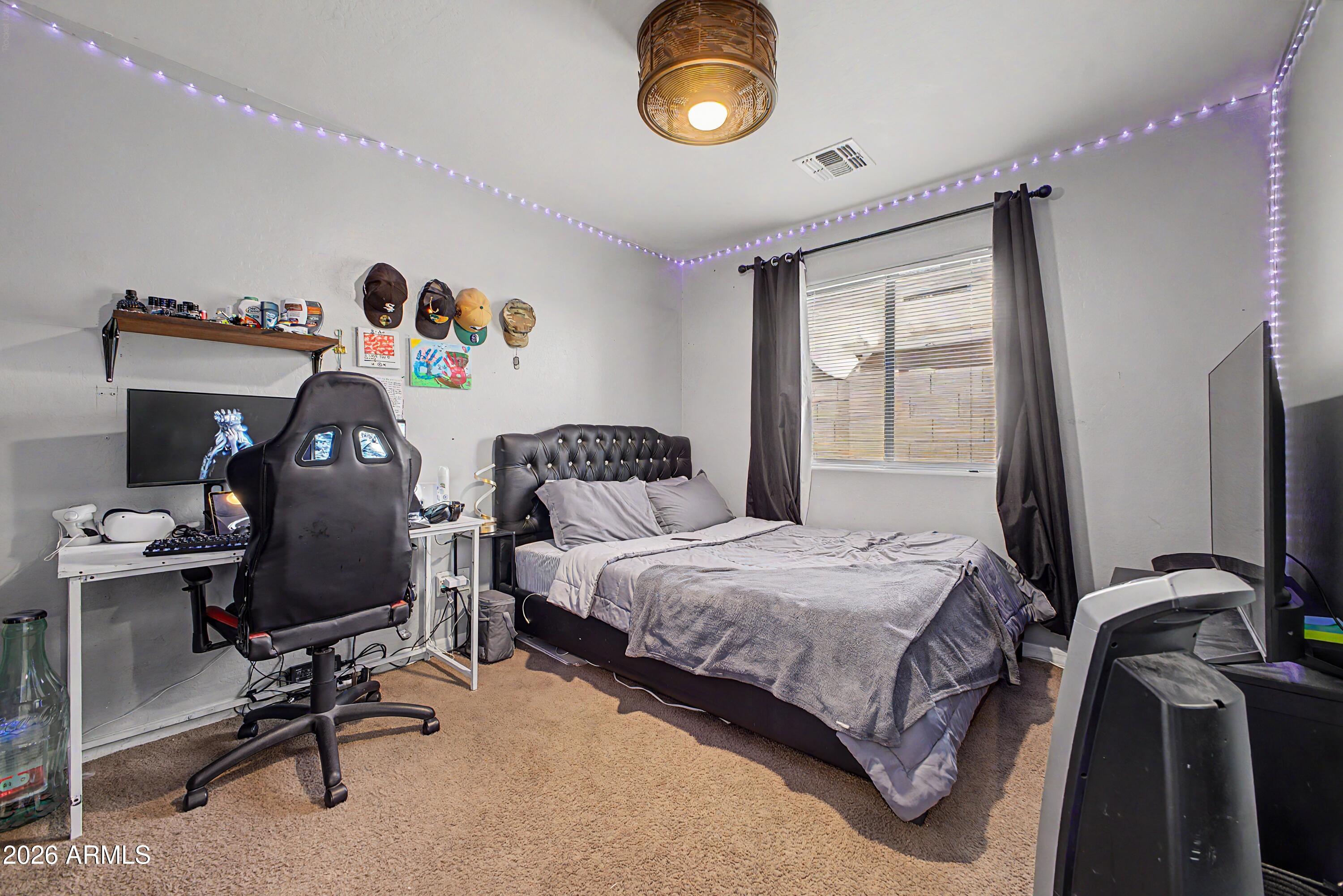 25652 West Rio Vista Lane Buckeye, AZ 85326 - Photo 26 of 32 a bedroom with a bed and a window