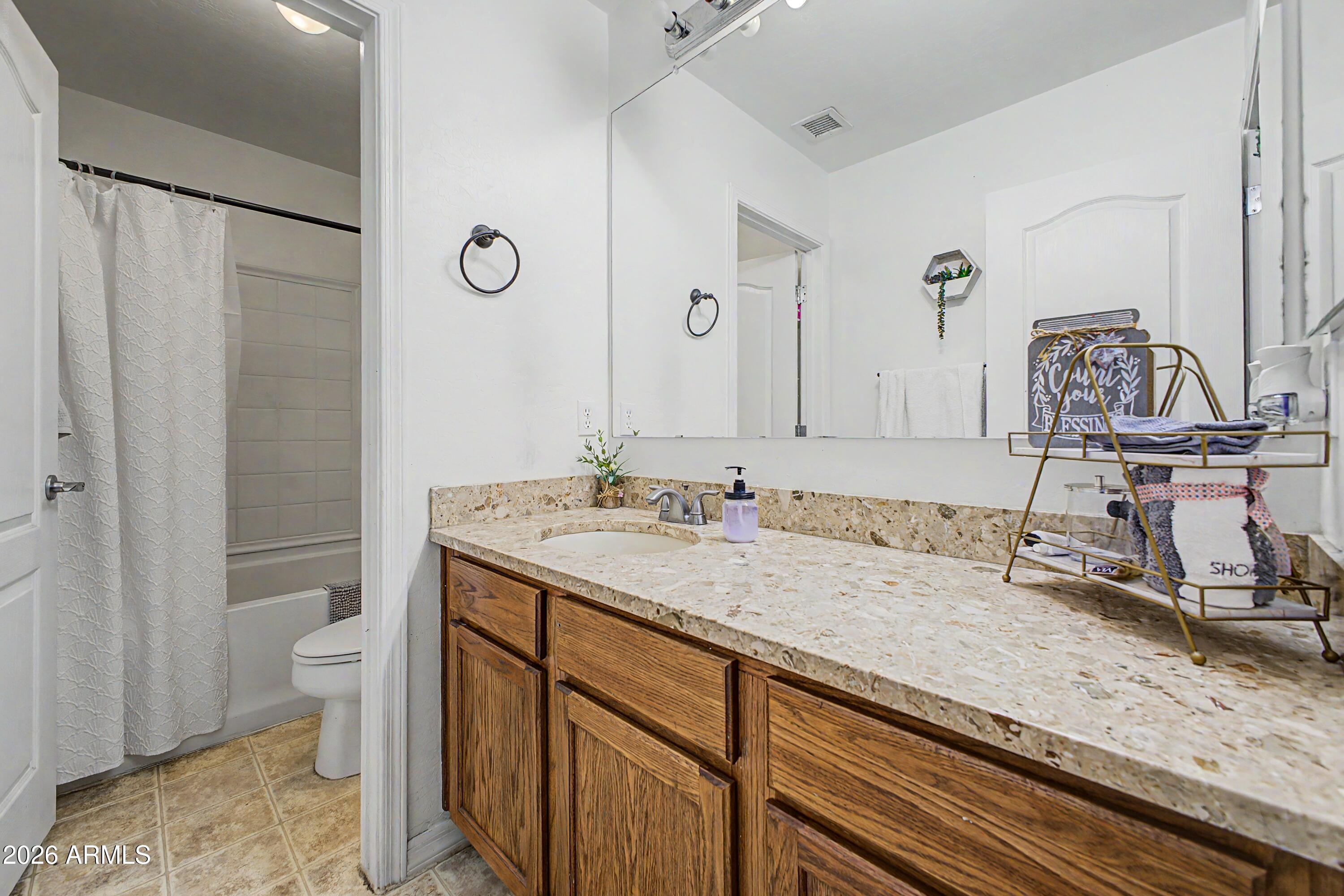 25652 West Rio Vista Lane Buckeye, AZ 85326 - Photo 29 of 32 a bathroom with a sink and a toilet