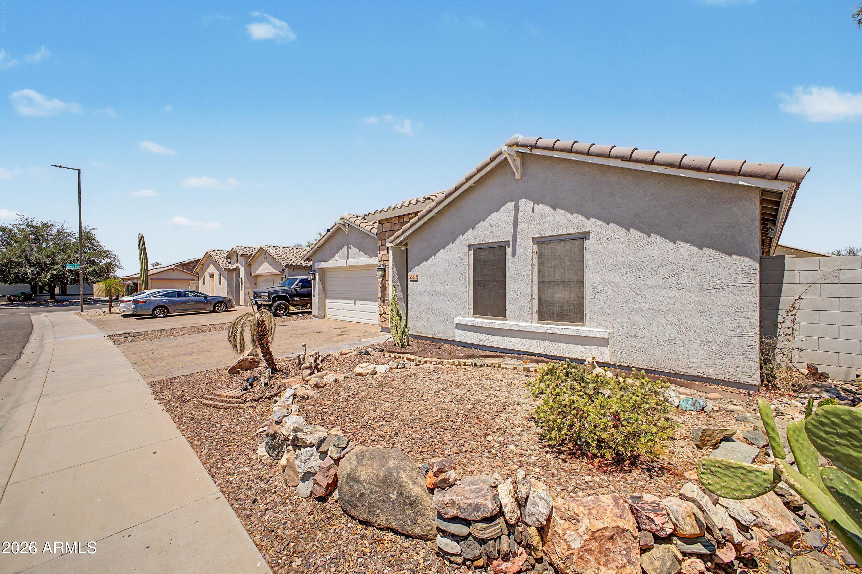 25652 West Rio Vista Lane Buckeye, AZ 85326 - Photo 3 of 32 a front view of a house with a yard