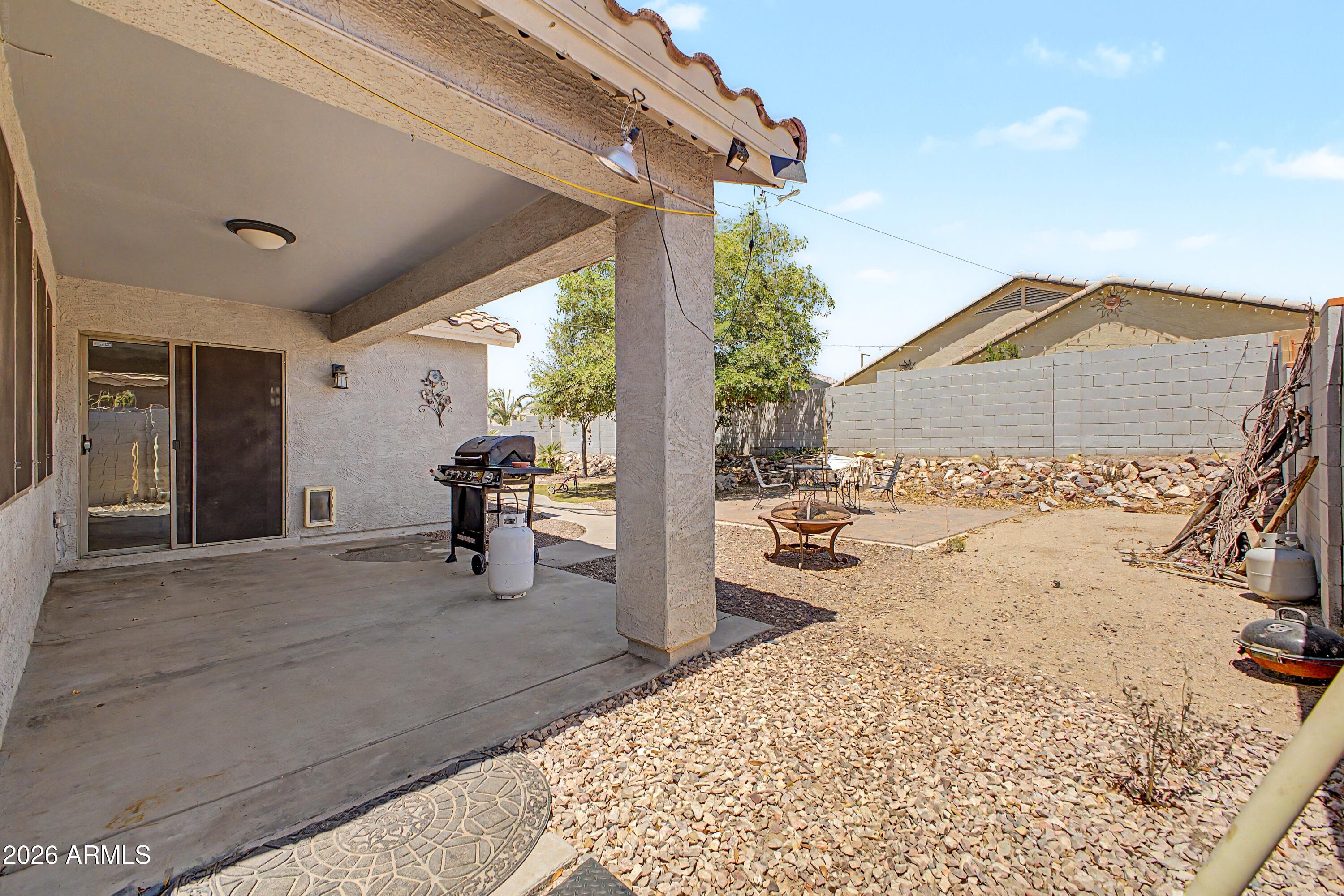 25652 West Rio Vista Lane Buckeye, AZ 85326 - Photo 31 of 32 a view of a porch with furniture and floor to ceiling window