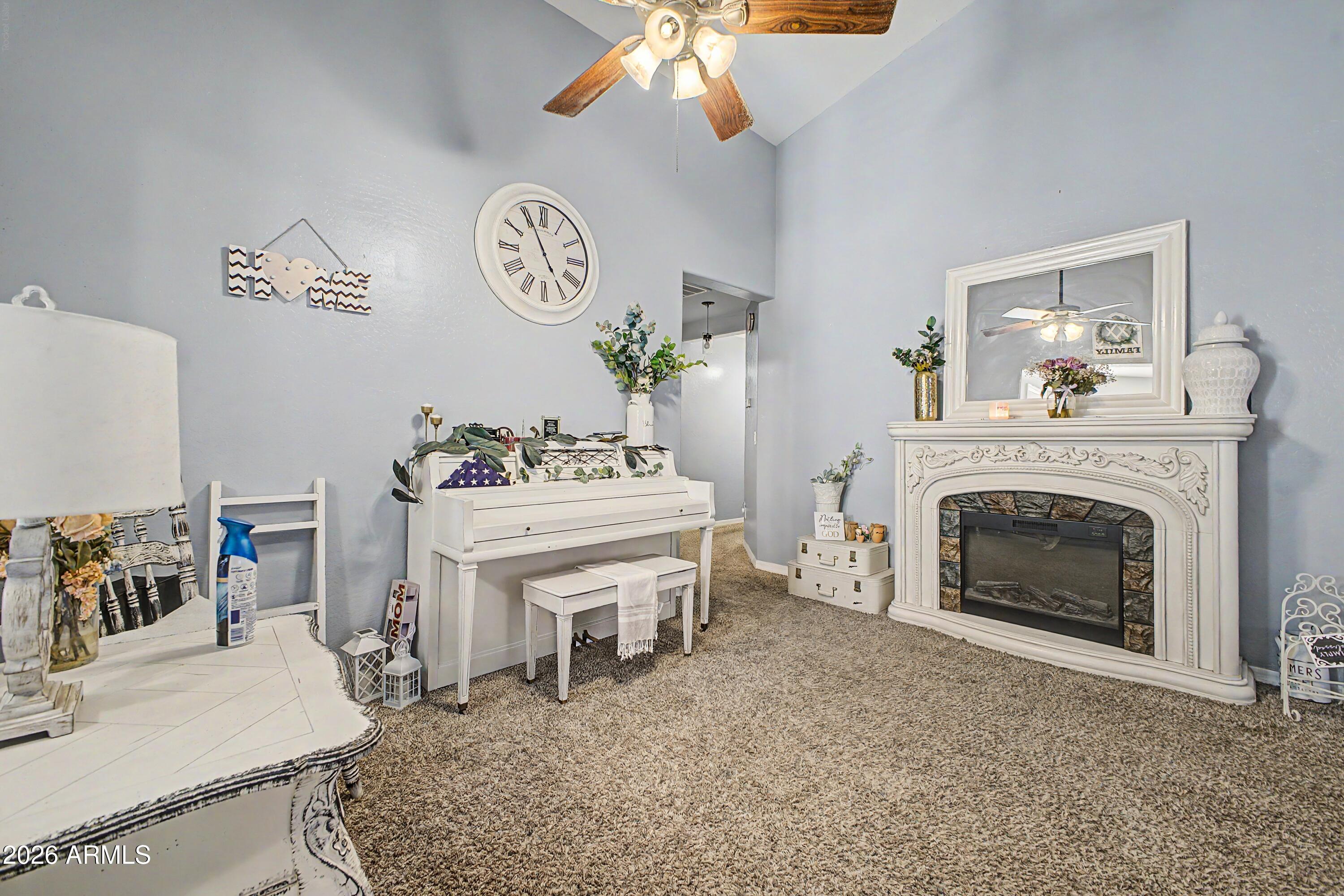 25652 West Rio Vista Lane Buckeye, AZ 85326 - Photo 5 of 32 a living room with furniture a fireplace and a table