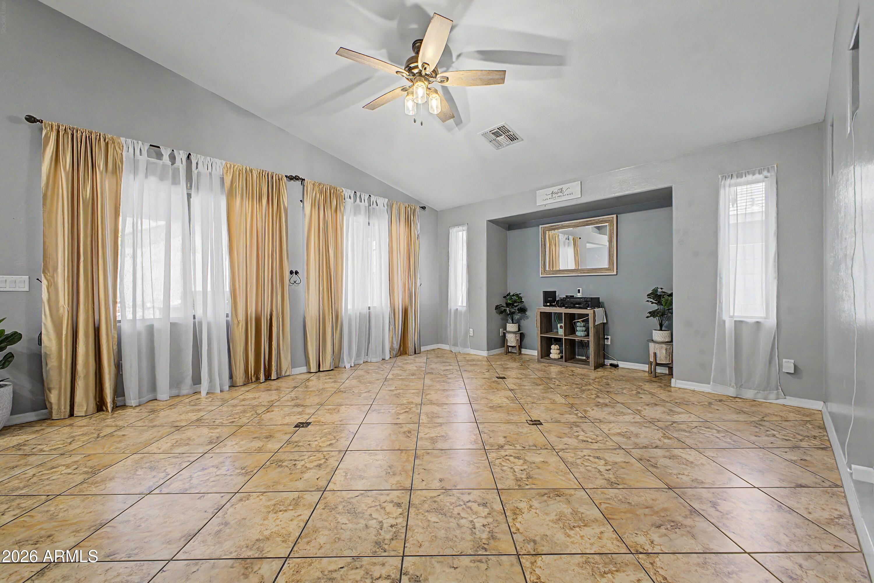 25652 West Rio Vista Lane Buckeye, AZ 85326 - Photo 9 of 32 a view of a livingroom with a chandelier fan and windows