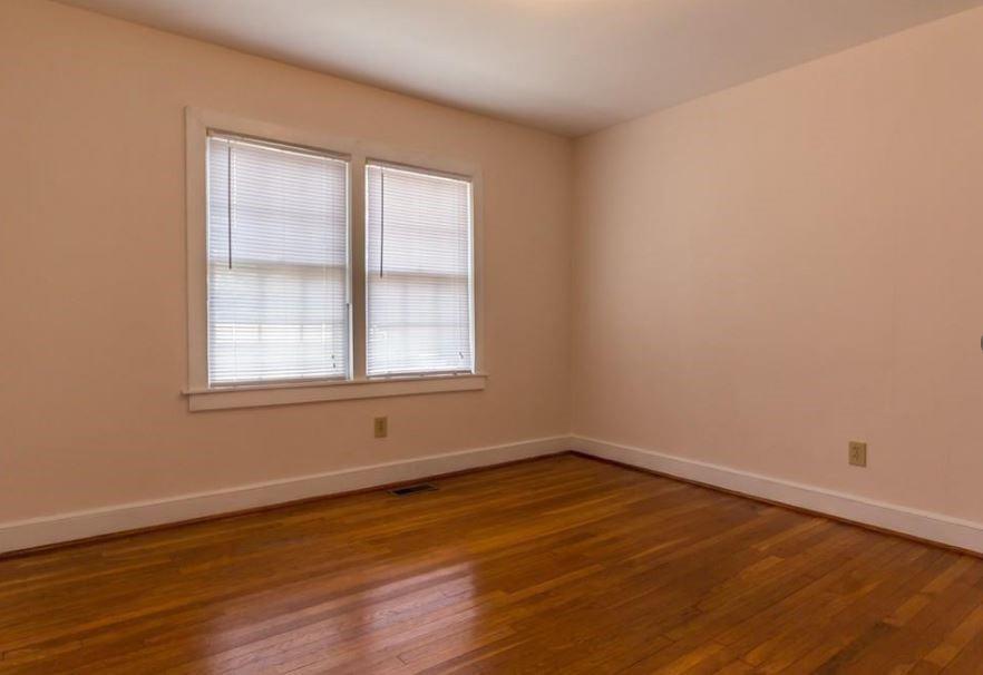 79 Ayers Avenue Marietta, GA 30060 - Photo 5 of 16 a view of an empty room with wooden floor and a window