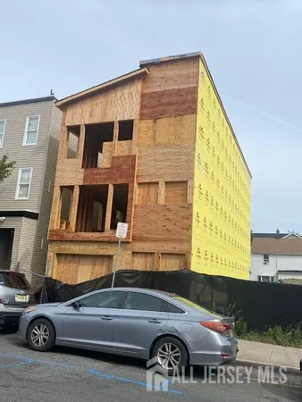 a front view of a house with parking space