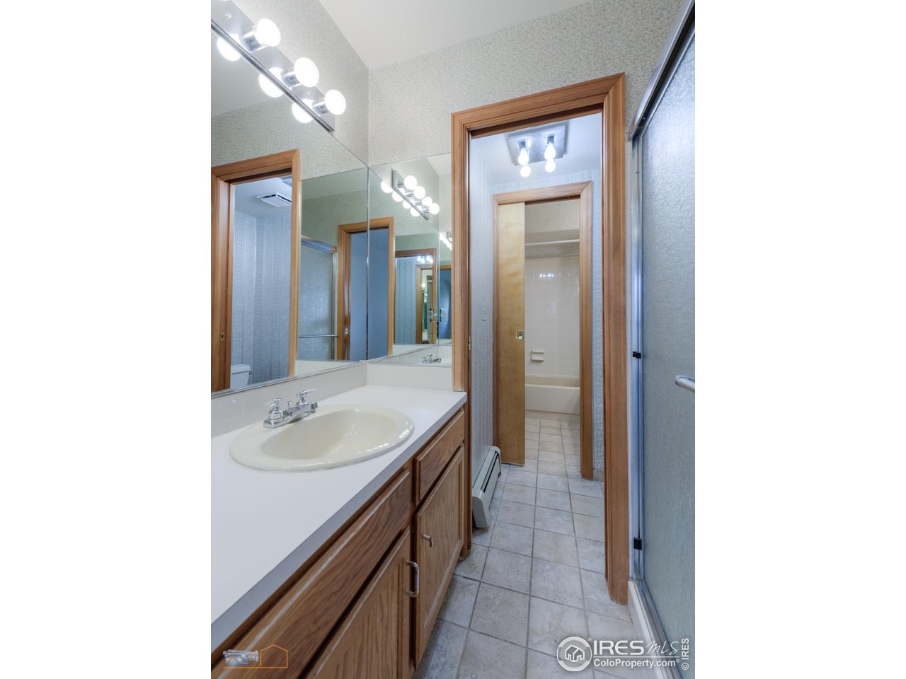 3104 Bell Drive Boulder, CO 80301 - Photo 31 of 40 a bathroom with a sink a mirror and a shower
