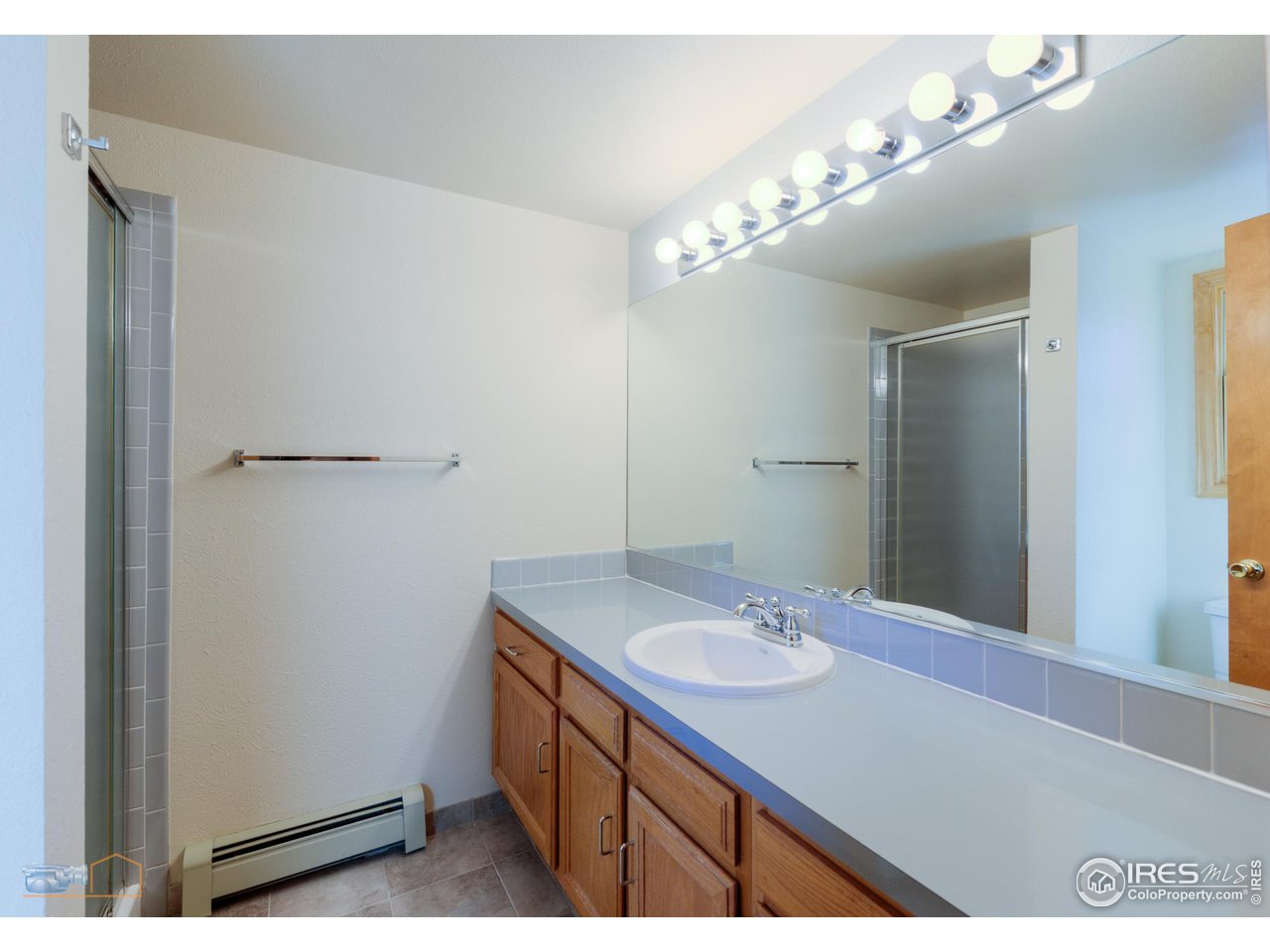 3104 Bell Drive Boulder, CO 80301 - Photo 35 of 40 a bathroom with a sink vanity and a mirror