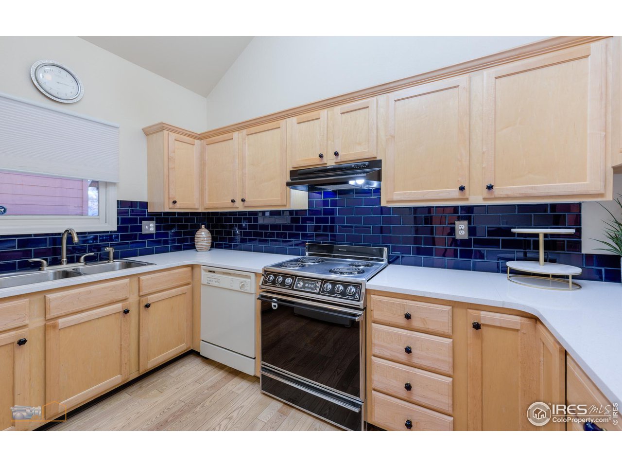 3104 Bell Drive Boulder, CO 80301 - Photo 9 of 40 a kitchen with stainless steel appliances granite countertop a stove a sink and white cabinets