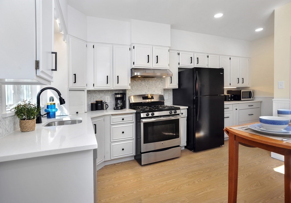 7 Lester Place Boston, MA 02130 - Photo 11 of 33 a kitchen with stainless steel appliances a stove refrigerator sink and cabinets