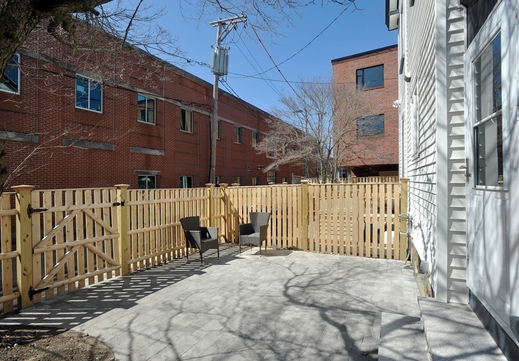 7 Lester Place Boston, MA 02130 - Photo 15 of 33 a view of a brick house with wooden fence