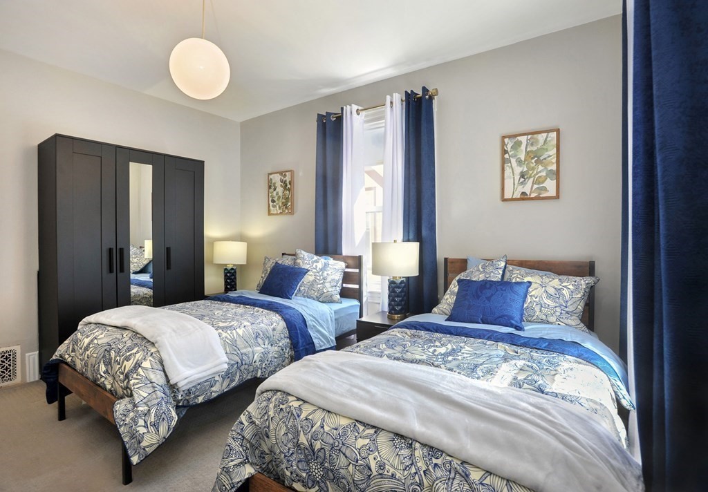 7 Lester Place Boston, MA 02130 - Photo 19 of 33 a bedroom with two beds and painting on the wall