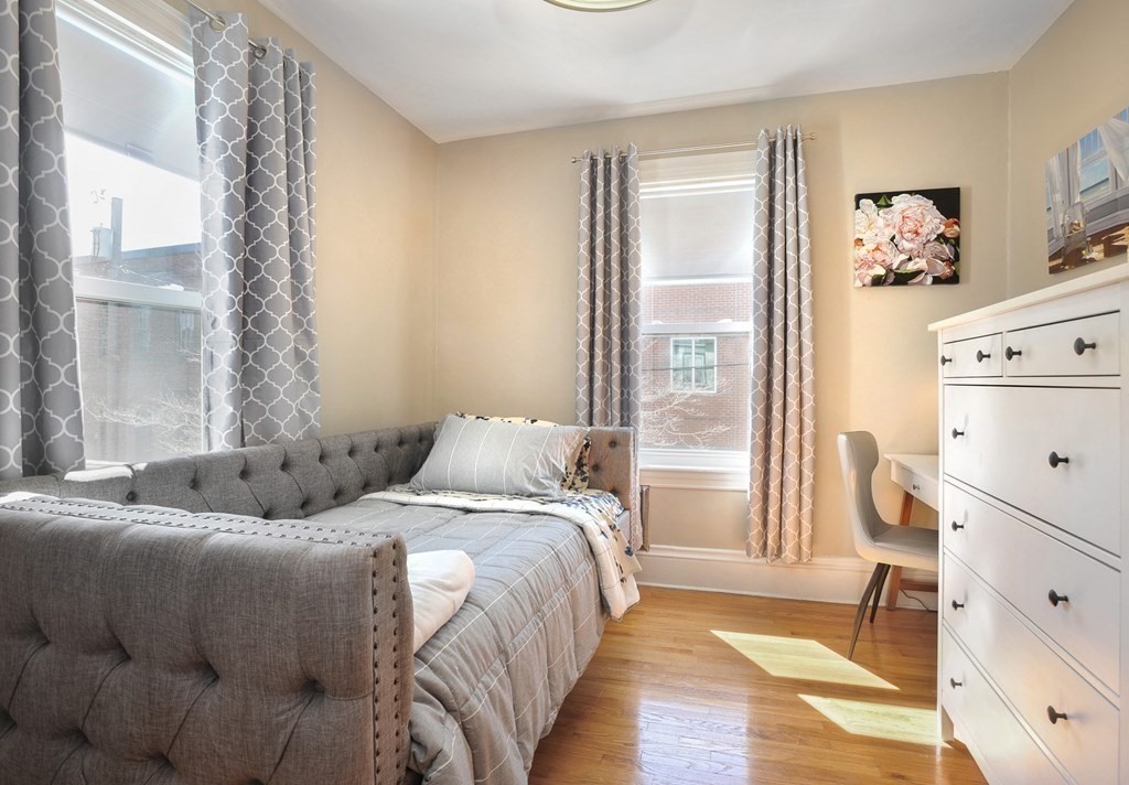 7 Lester Place Boston, MA 02130 - Photo 22 of 33 a bedroom with a bed and wooden floor