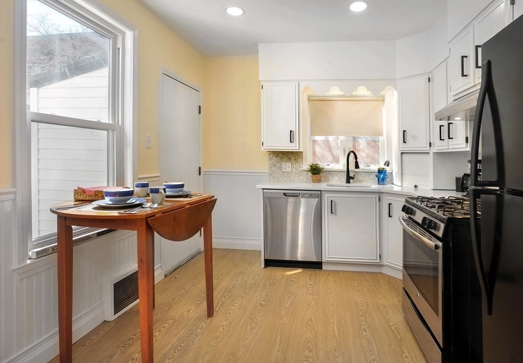7 Lester Place Boston, MA 02130 - Photo 9 of 33 a kitchen with stainless steel appliances granite countertop a sink stove and refrigerator