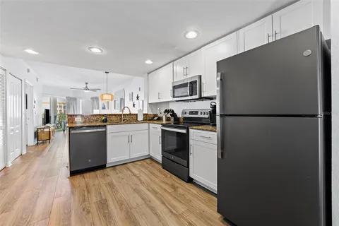 a kitchen with appliances cabinets and a counter top space
