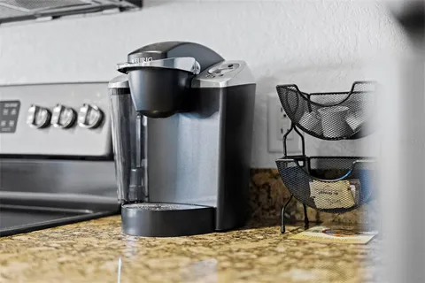 a living room with furniture a dining table and a chandelier