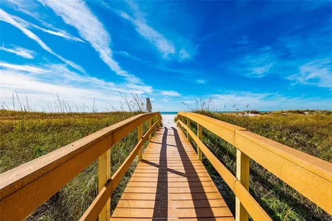 an aerial view of a house with a swimming pool and outdoor seating