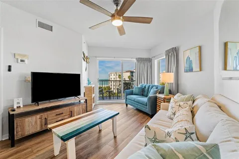 a living room with furniture a lamp and a chandelier