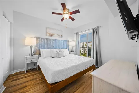 a bathroom with a granite countertop sink a toilet a mirror and shower