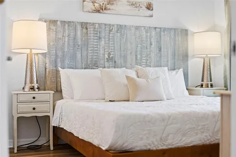a view of a swimming pool with a lawn chairs under an umbrella
