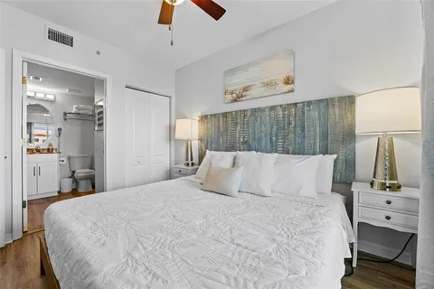 a view of a hallway with wooden floor and entryway