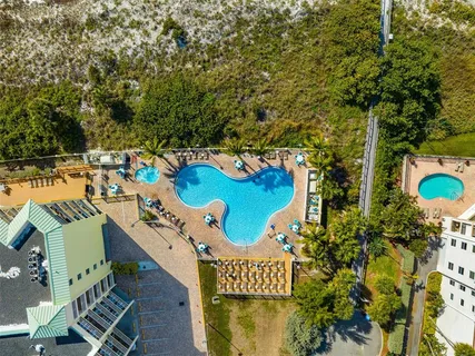 a view of a hallway with wooden floor and a bathroom
