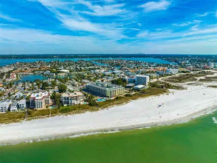 a kitchen with stainless steel appliances granite countertop a refrigerator oven a sink dishwasher and white cabinets with wooden floor