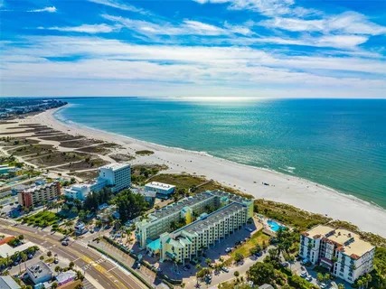 a kitchen with a refrigerator and a stove top oven