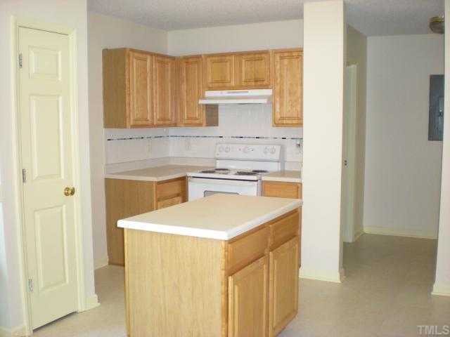 4828 Silverdene Street Raleigh, NC 27616 - Photo 4 of 7 a kitchen with a sink stove and cabinets