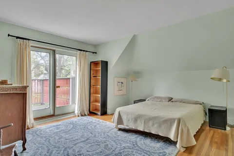 a bedroom with a large bed and a window