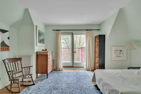 a bedroom with a bed and chair