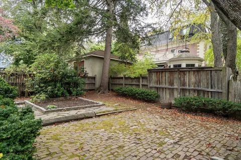 a dining room with furniture window and wooden floor