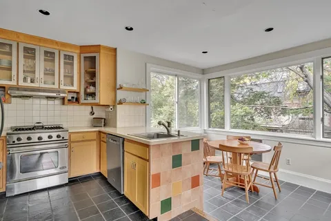 a kitchen with a stove a table and chairs