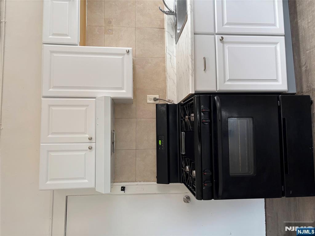 28 Fair Street, Unit 28B Hackensack, NJ 07601 - Photo 1 of 8 a stove top oven sitting inside of a kitchen