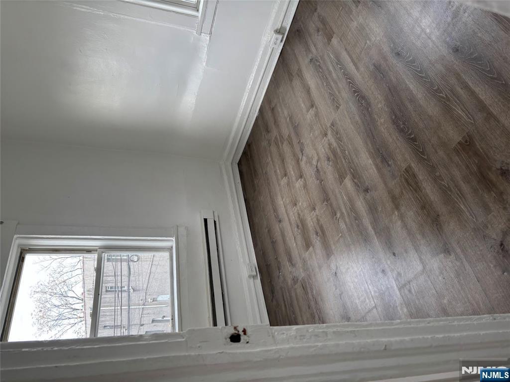 28 Fair Street, Unit 28B Hackensack, NJ 07601 - Photo 5 of 8 a view of a small space with wooden floor and a window