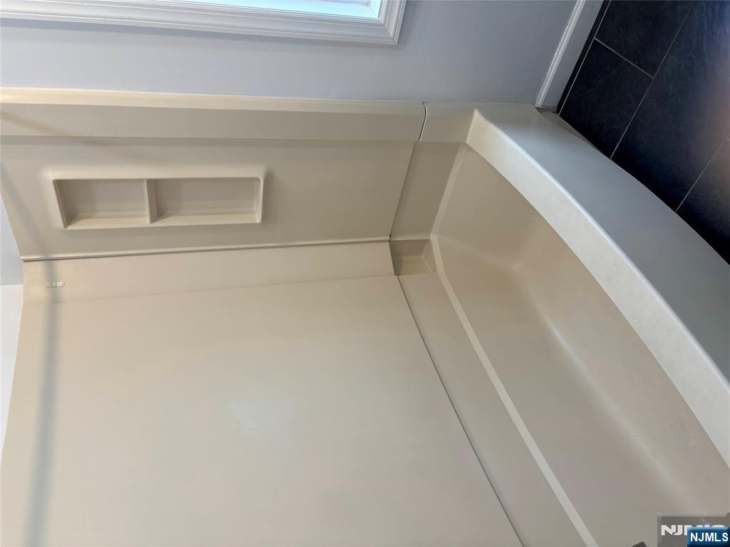 28 Fair Street, Unit 28B Hackensack, NJ 07601 - Photo 8 of 8 a bath tub sitting next to a white sink and vanity