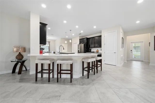 a large kitchen with a table and chairs
