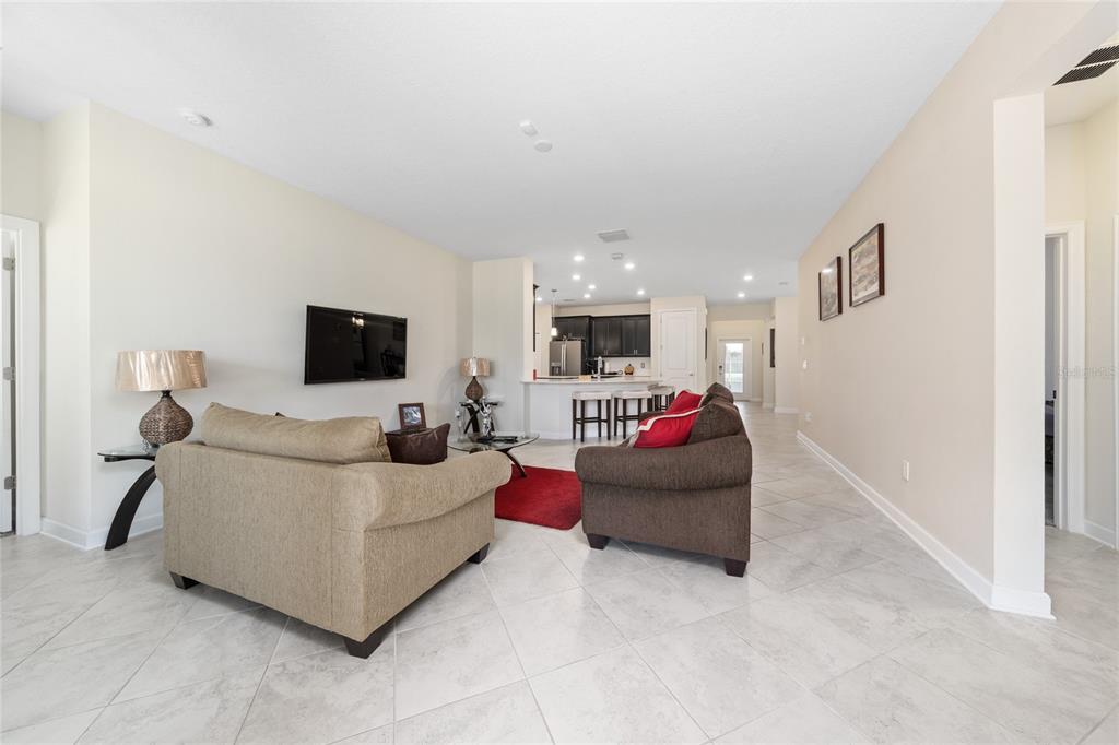1701 Snapper Street St. Cloud, FL 34771 - Photo 14 of 29 a living room with furniture and a flat screen tv